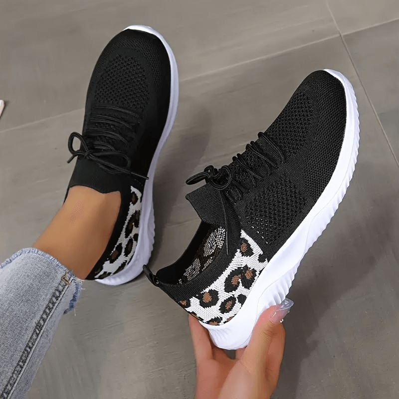 Breathable black sports sneakers with leopard print, soft sole, and mesh design for women, perfect for comfort and style.